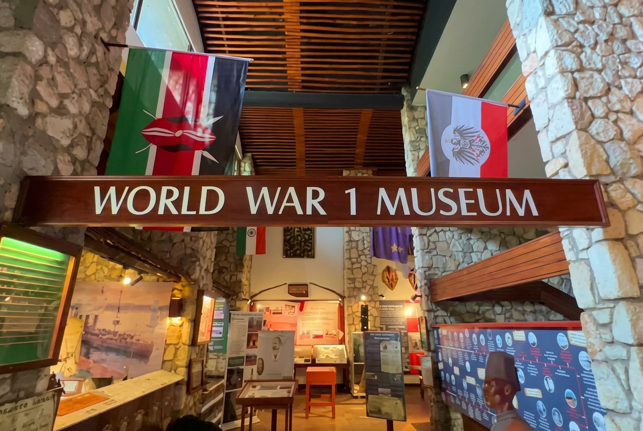 Entrance of the World War 1 Museum at Taita Hills with stone walls and hanging flags